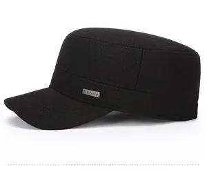Detail of black military flat top hat showing textured fabric and Fashion M metal tag