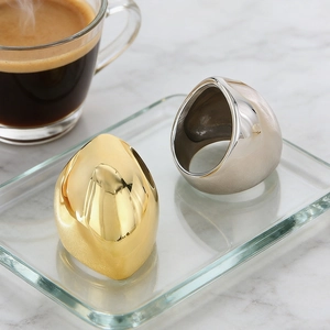 Detail of minimalist gold and silver thick rings with irregular organic sculptural shapes