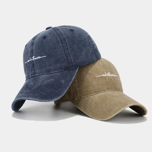 Washed cotton baseball caps in navy and khaki with whatever embroidery detail