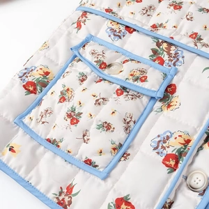 Quilted floral jacket with light blue trim and button pocket detail for women