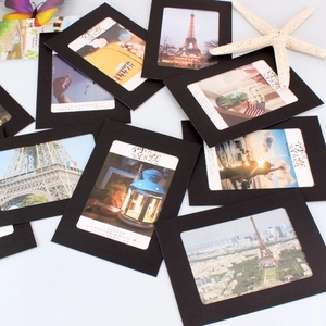 Set of black kraft paper photo frames with assorted scenic art prints and starfish decor