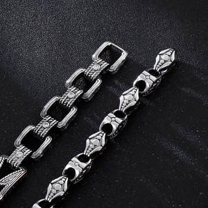 Macro shot of vintage style stainless steel chain bracelets with intricate cross details