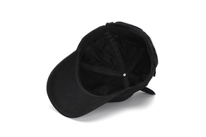 Detail of internal black baseball cap structure with reinforced stitching and twill fabric