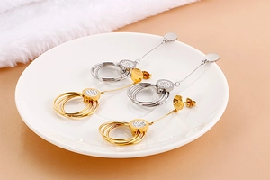 Detailed view of long hollow circle drop earrings with crystals in gold and silver