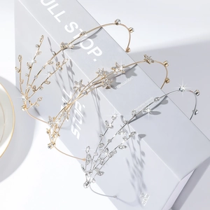 Detailed close-up of crystal-encrusted gold and silver star and leaf headbands