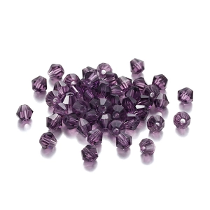 Macro shot of deep purple faceted bicone crystal glass beads for jewelry DIY crafts