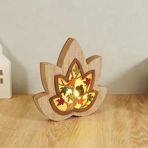 Lighted wooden maple leaf ornament with carved squirrel silhouette and forest theme