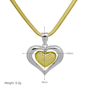 Macro detail of dual-tone heart pendant with dimensions 30mm x 36mm on snake chain