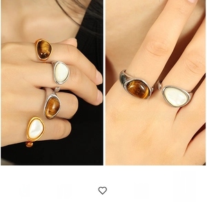 Detailed view of French vintage tiger eye and mother of pearl ring on a model hand