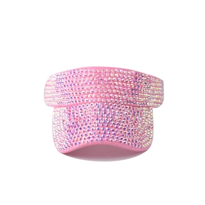Close-up of pink sun visor hat covered in shimmering iridescent rhinestones