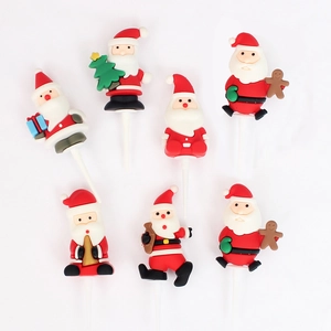 Detail view of 7 assorted soft rubber Santa Claus cake toppers for Christmas decoration