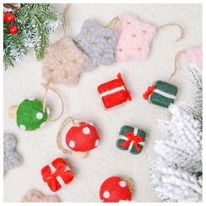 Close-up of wool felt Christmas ornaments including stars, gift boxes and mushrooms