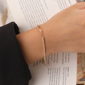 Luxurious gold-plated paperclip chain bracelet with shimmering pavé zircon detail on wrist