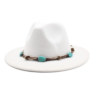 Close-up of white wool fedora hat featuring ethnic trim with teal resin stones