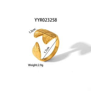 Detail showing golden adjustable leaf-shaped stainless steel ring with etched veins