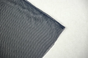 Close-up of high-quality breathable black mesh fabric with reinforced edge stitching