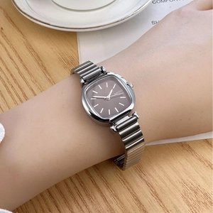 Elegant silver square watch with grey dial and metal band on model's wrist