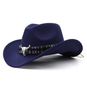 Detail of navy blue felt cowboy hat with ethnic woven band and silver bull head ornament