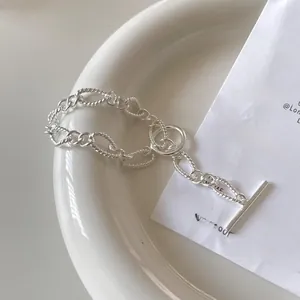 Detailed close-up of 925 sterling silver chain bracelet with OT toggle clasp on a plate