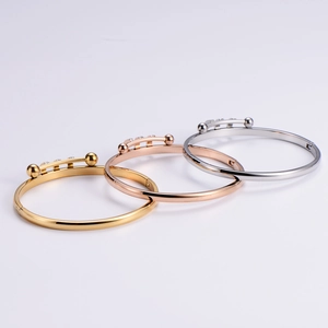 Polished titanium steel bangles in gold, rose gold and silver with triple bead design