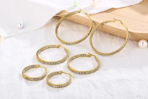 Detail of 18K gold-plated stainless steel hoop earrings with sparkling white rhinestones