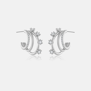 Macro detail of silver C-shaped earrings with triple rows and sparkling cubic zirconia stones