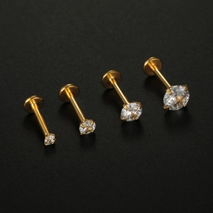 Macro view of gold titanium steel labret studs featuring four sizes of clear zircons