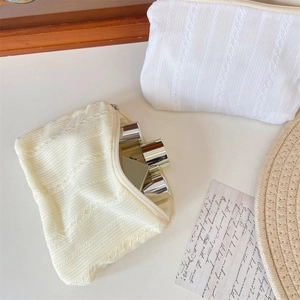Detail of quilted texture makeup bag showing spacious interior for cosmetic storage