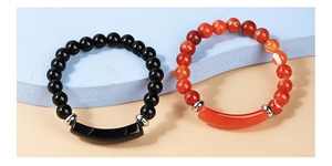 Detailed shot of black and orange agate beaded elastic bracelets with silver spacers