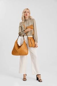 Detailed set of three vintage brown soft leather bags including tote and crossbody bags