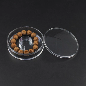 Macro shot of a wooden prayer bead bracelet inside a transparent round acrylic display box