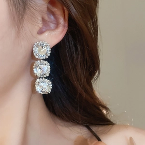 Detailed view of elegant silver crystal drop earrings with sparkling circular pavé accents