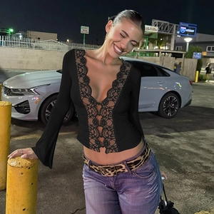 Close-up of elegant black lace trim and button detail on a sexy women's summer cardigan