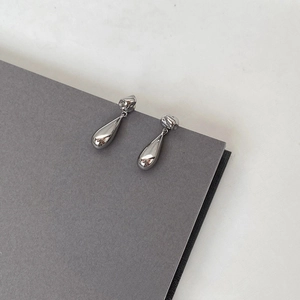 Minimalist silver lava teardrop earrings with irregular texture and polished finish