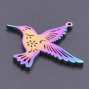 Detailed view of rainbow-plated stainless steel hummingbird pendant with hollow floral pattern