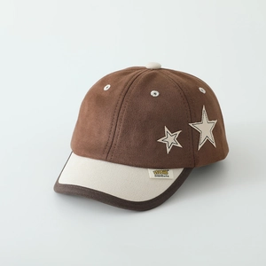 Detail of star embroidery and contrast piping on kids suede baseball cap