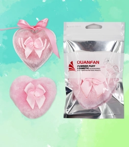 Pink heart-shaped velvet powder puff in various packaging styles with ribbon detail