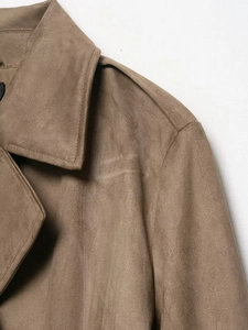 Detail view of the lapel and texture on a brown faux suede long trench coat