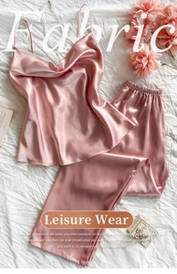 Detailed view of pink silk satin camisole and pants set with high-gloss texture