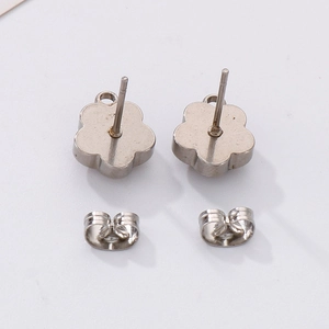 Detailed view of flower shaped stainless steel stud earrings with butterfly backings