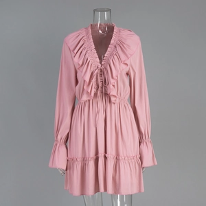 Detail of light pink chiffon dress with V-neckline, ruffles, and tiered bell sleeves
