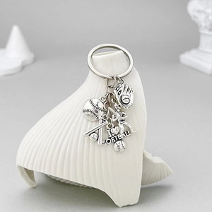 Antique silver softball keychain with bat, glove, and athlete charm pendants