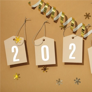 Detail of beige cardstock gift tags featuring printed numbers for festive holiday decor