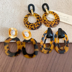 Three pairs of vintage leopard print acrylic resin earrings with tortoiseshell texture