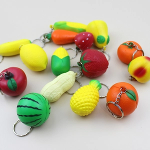 Flat lay of thirteen assorted realistic fruit and vegetable charms in vibrant PU foam