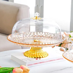 European amber glass cake stand with a transparent crown dome and gold metal base pedestal