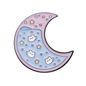 Detail view of crescent moon enamel pin with cartoon cats and starry sky pattern