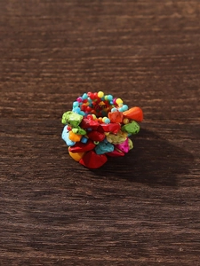 Detailed top view of handmade bohemian ring with colorful irregular natural stone beads