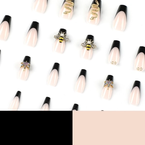French tip press-on nails with black patchwork, golden bee, snake and rhinestone accents