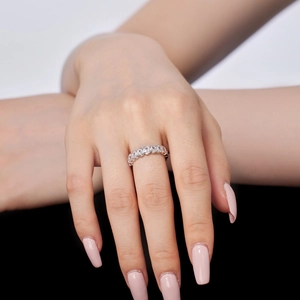 Eternity ring with oval-cut cubic zirconia in polished silver setting on model's hand